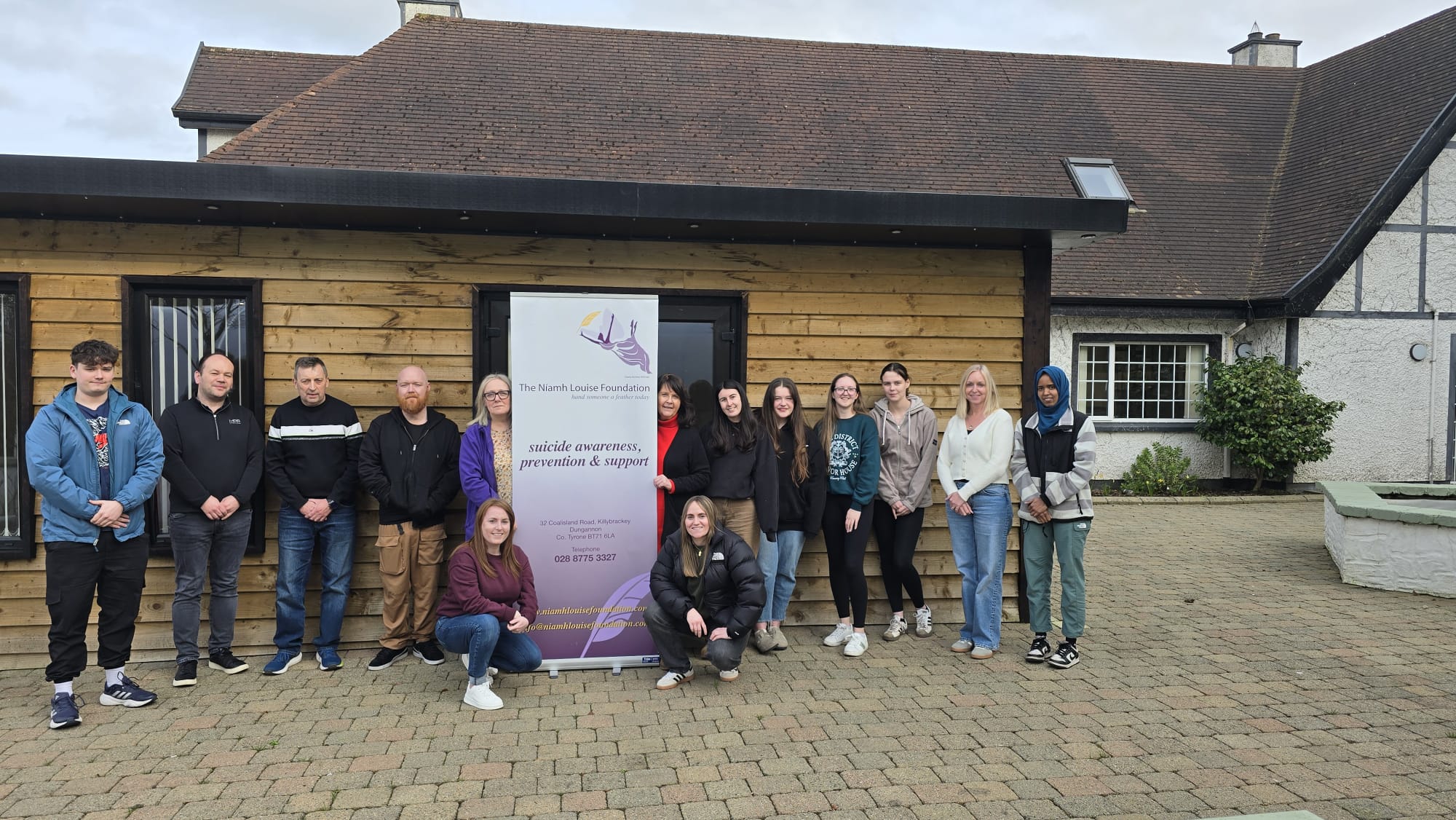 Niamh Louise Foundation team and volunteers gathered with the foundation banner