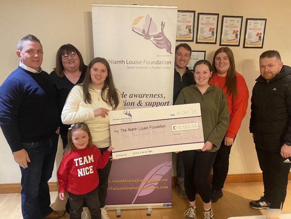 The Burns Family presenting a £10,000 cheque donation to the Niamh Louise Foundation