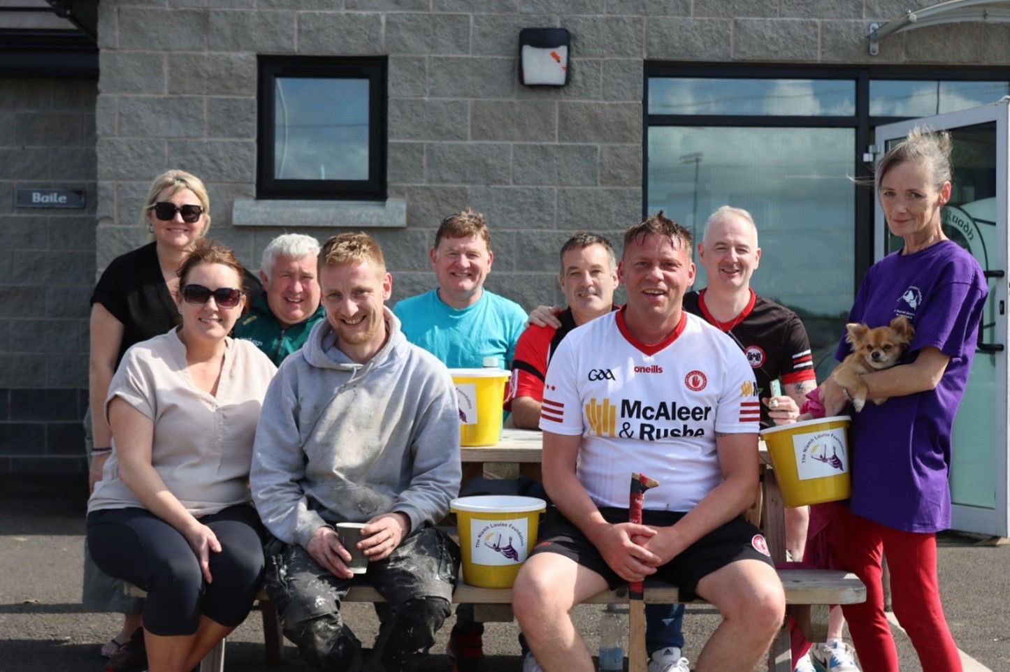 Community fundraisers with collection buckets at a local GAA club