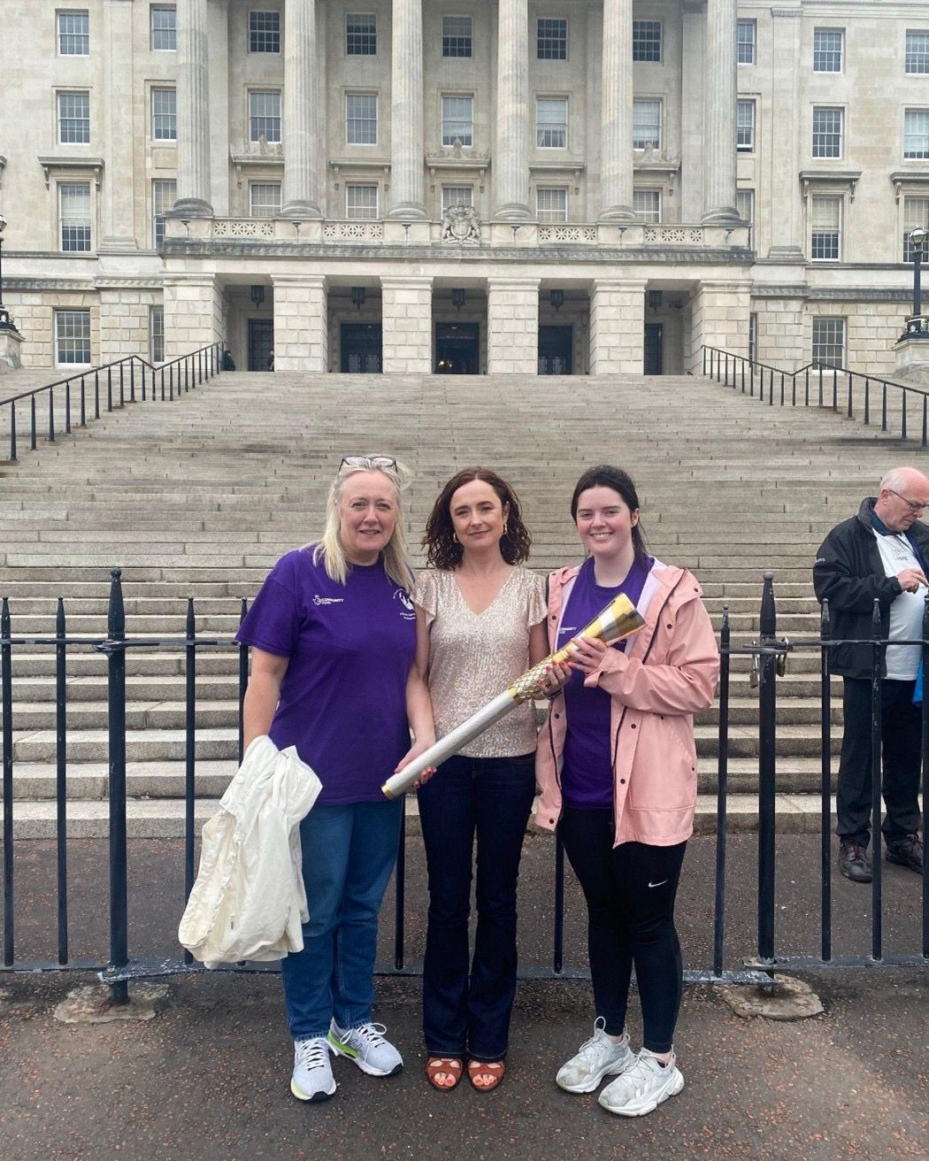 Niamh Louise Foundation team members with the community torch at Stormont